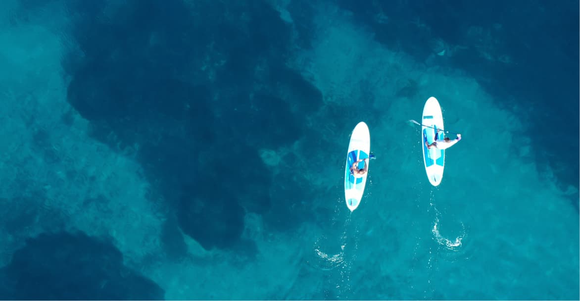 Arial photo of two people paddle boarding